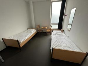 Postel nebo postele na pokoji v ubytování Arena Hostel & Monteurzimmer