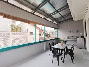 a dining room with a table and chairs and a window at Ipoh town centre glamping home 13pax in Ipoh
