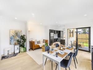 a living room with a table and a dining room at Well decorated cozy 3BR home at Browns Plain in Browns Plains