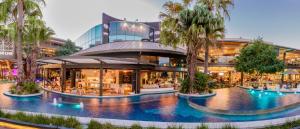 a shopping mall with palm trees in front of it at Conveniently Located Luxury 4BR Townhouse in Brisbane