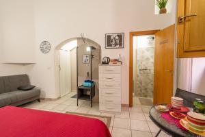 a room with a bed and a table and a bathroom at B&B Martini Home 11 in Altamura