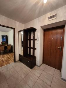 a room with a wooden door and a dining room at Słoneczny apartament 2 in Duszniki Zdrój