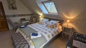 a bedroom with a large bed with pillows and a window at Au Bonheur de Cisse in Chouzy-sur-Cisse