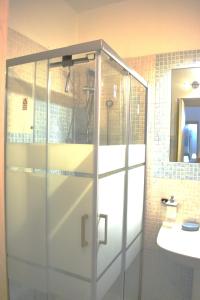 a glass shower in a bathroom with a sink at Angolo Di Sicilia in Palermo