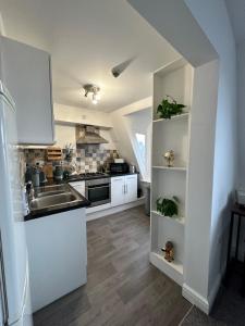 a kitchen with a sink and a stove top oven at The Lookout, Bridlington in Bridlington