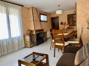 a living room with a table and a dining room at Casa Lola Beceite, terraza, barbacoa y chimenea in Beceite
