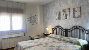 a bedroom with a bed with a quilt on it at Casa Lola en Beceite rodeados de montañas y ríos in Beceite