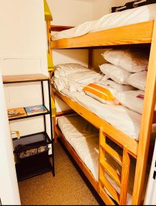 two bunk beds in a dorm room with aartments at Eden Studio La foux d Allos centre station , 50 m du centre avec terrasse plein sud , chambre 4 couchages in La Foux