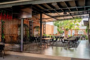 an empty patio with tables and chairs in a restaurant at Megal Suites Hotel in Ciudad del Este