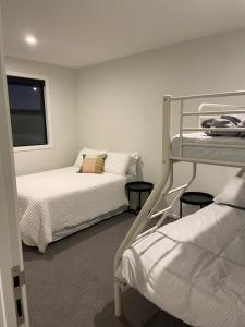 a bedroom with two bunk beds and a window at Beckford House in Methven