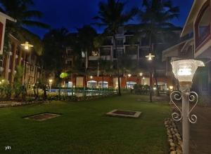 a street light in the middle of a park at night at Luxurious Spacious 2 BHK With Pool Wi-Fi Cooking Gas Gym in Calangute
