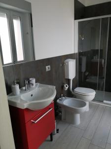a bathroom with a white sink and a toilet at MAWA in Ferrara
