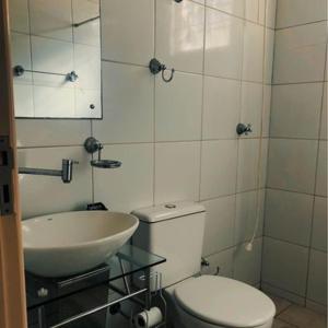 a bathroom with a toilet and a sink at Kasa Kaya in Araraquara