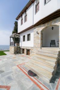 a building with a wooden bench in front of it at Mermaid Villa & Apartment Common Areas in Koropi