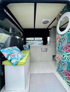 uma caravana com um sofá nas traseiras em On Road- feel freedom with campervan! em El Guincho