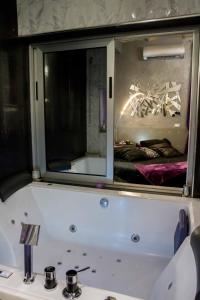 ein Badezimmer mit einem Spiegel über einem weißen Waschbecken in der Unterkunft Jacuzzi Love SuiteSweetRome in Rom