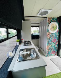 an rv kitchen with a sink and a stove at On Road- feel freedom with campervan! in El Guincho