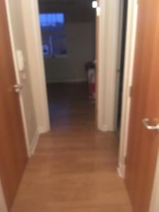 a view of a hallway from a room with two doors at Lovely Two bed flat located in the heart of Dunstable in Dunstable