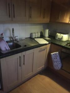 a kitchen with a sink and a counter top at Lovely Two bed flat located in the heart of Dunstable in Dunstable