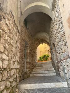 an alley with stone walls and stairs in a building at Grotta Abati in Gaeta