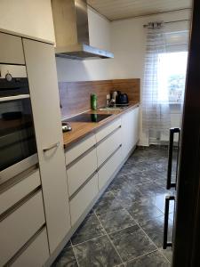 a kitchen with white cabinets and a sink at schöne, modernisierte Wohnung - Dudweiler in Saarbrücken