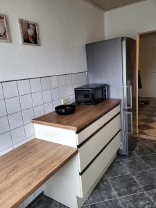 a kitchen with a counter with a microwave on it at schöne, modernisierte Wohnung - Dudweiler in Saarbrücken