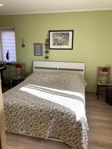 a bedroom with a bed with a leopard print blanket at Vie Nature Rochefort in Rochefort