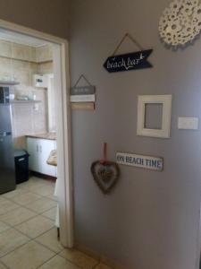 a door to a kitchen with a heart on the wall at Afsaal Holiday Flats in Amanzimtoti