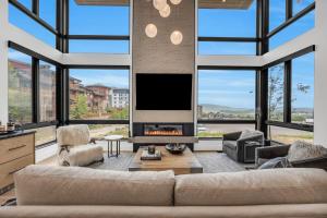 a living room with a couch and a fireplace at Ridgeline Ski in Townhouse wHot Tub in Park City