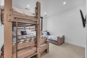 two bunk beds in a room with two beds at Ridgeline Ski in Townhouse wHot Tub in Park City