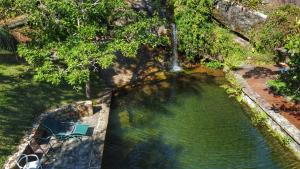 an overhead view of a pool of water with a waterfall at Casas D’Água Doce - Casa da Árvore in Ilhabela +45 photos