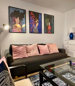 a living room with a couch and some pictures on the wall at Apartament KaMaRo in Słubice