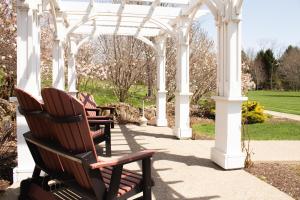 a group of chairs sitting under a white gazebo at Berlin Resort in Millersburg