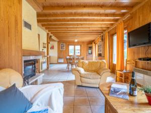 a living room with a couch and a tv in a house at Chalet Mendiaux by Interhome in Saint-Gervais-les-Bains