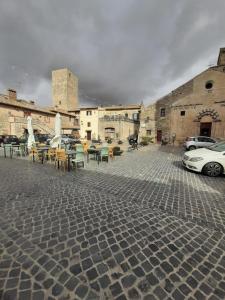 a patio with tables and chairs in a parking lot at La Dolce Volta in Tarquinia