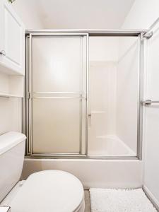 a white bathroom with a shower and a toilet at Cozy House With Ocean View - PCH-R-MA in Malibu