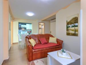 a living room with a brown leather couch at Holiday Home Nena by Interhome in Buje