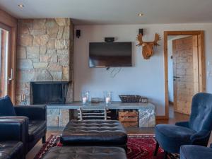 a living room with a fireplace and a tv at Apartment Montagnard 10 by Interhome in Nendaz