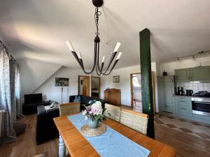 a dining room and living room with a dining table at Apartment Rügen by Interhome in Dargun