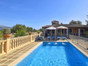 a house with a swimming pool next to a house at Holiday Home Tramuntana by Interhome in Moscari