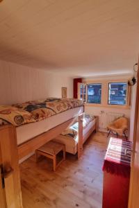 um quarto com uma cama e duas janelas em Apartment Bachhüsi by Interhome em Zweisimmen