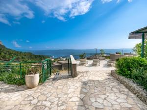 a patio with a view of the ocean at Holiday Home Drago by Interhome in Veliko Brdo