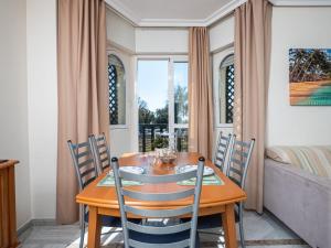 a dining room with a wooden table and chairs at Apartment Lorcrimar by Interhome in Marbella