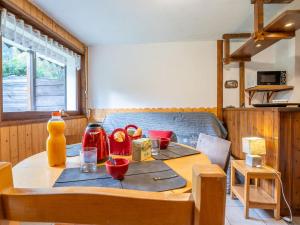 a wooden table in a room with a tableablish at Apartment Clos des Outannes by Interhome in Chamonix