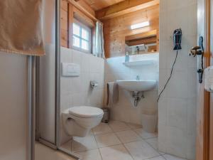 a bathroom with a toilet and a sink at Chalet Königsleiten 1 by Interhome in Königsleiten