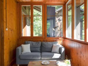 a living room with a couch and some windows at Chalet Dufaux by Interhome in Champex