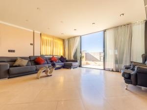 a large living room with couches and a large window at Holiday Home Masia Blanca by Interhome in Comarruga