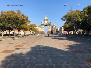 una calle con un arco en una ciudad con árboles en Casa Caruso, en Catania