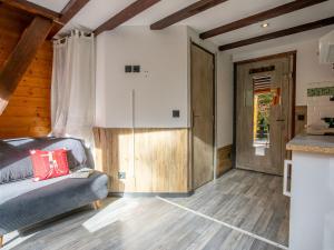 a living room with a couch and a wooden floor at Holiday Home Les Mazots de La Renardiere by Interhome in Chamonix-Mont-Blanc