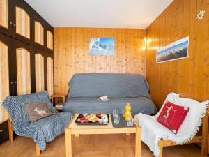 a bedroom with a bed and a table and a chair at Apartment Le Prarion by Interhome in Les Houches